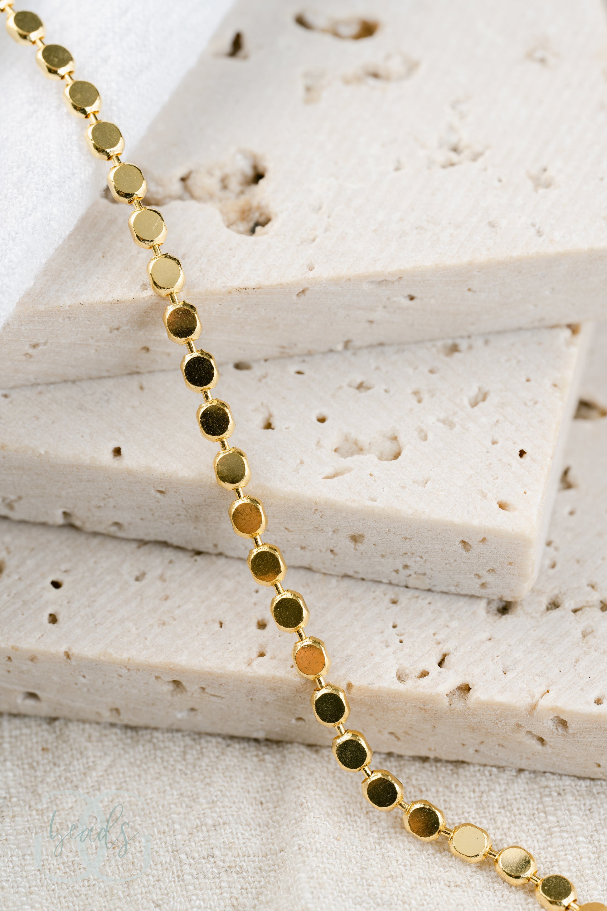A gold plated chain necklace where each chain link is a small circle - tying into the "dot" name!