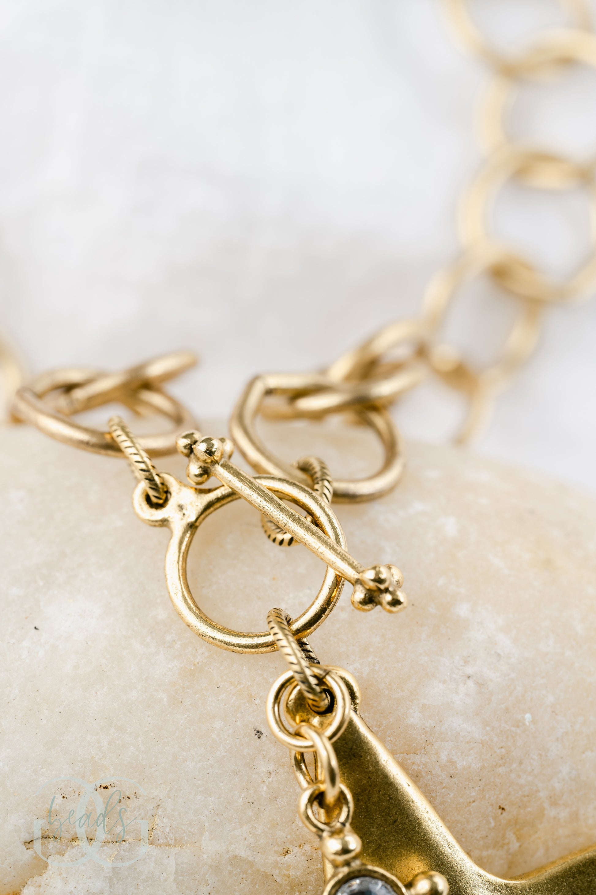 Front toggle closure on gold necklace.