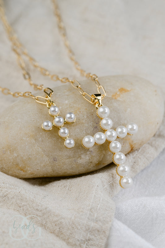 Two pearl cross necklaces on gold paperclip chains. One pearl cross is 1" and the other pearl cross is 1.5".