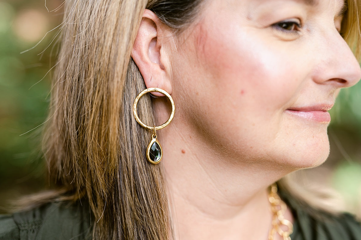 Round, gold earrings with a gold, teardrop pendant.